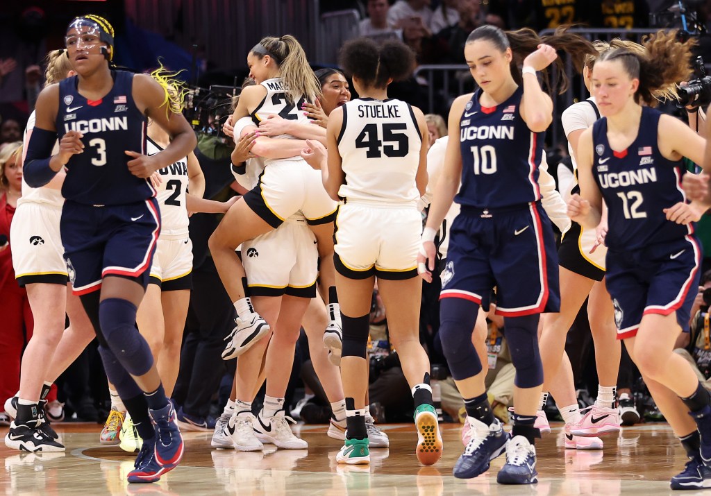 The Iowa Hawkeyes celebrate after beating the UConn Huskies 71-69 during the NCAA Women's Basketball Tournament Final Four semifinal game at Rocket Mortgage Fieldhouse 