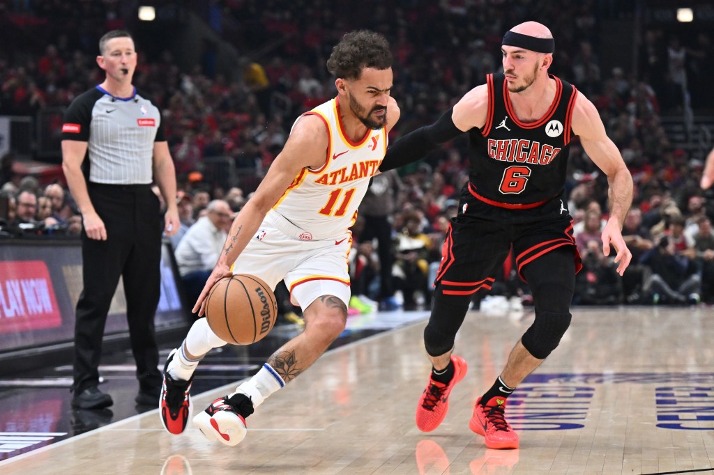 rae Young #11 of the Atlanta Hawks drives against Alex Caruso #6 of the Chicago Bulls in the first half during the play-in tournament