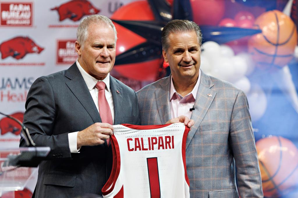 John Calipari of the Arkansas Razorbacks poses with Athletic Director Hunter Yurachek as he is introduced to the fans and the media at Bud Walton Arena on April 10, 2024 in Fayetteville, Arkansas. 