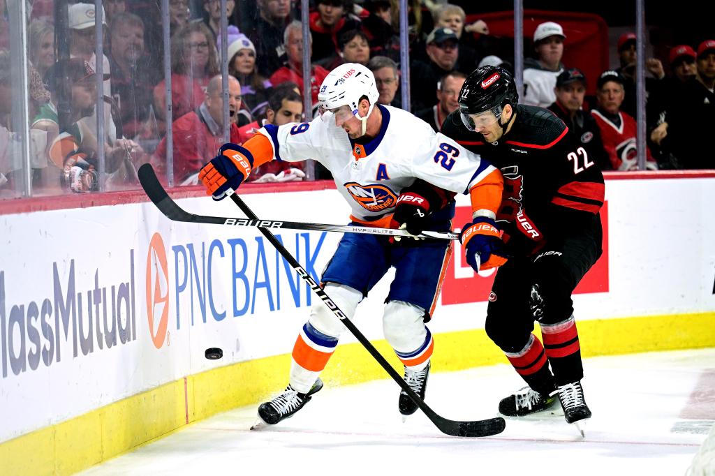 Brock Nelson #29 of the New York Islanders battles Brett Pesce #22 of the Carolina Hurricanes for the puck during the second period in Game Two of the First Round of the 2024 Stanley Cup Playoffs at PNC Arena on April 22, 2024 in Raleigh, North Carolina.