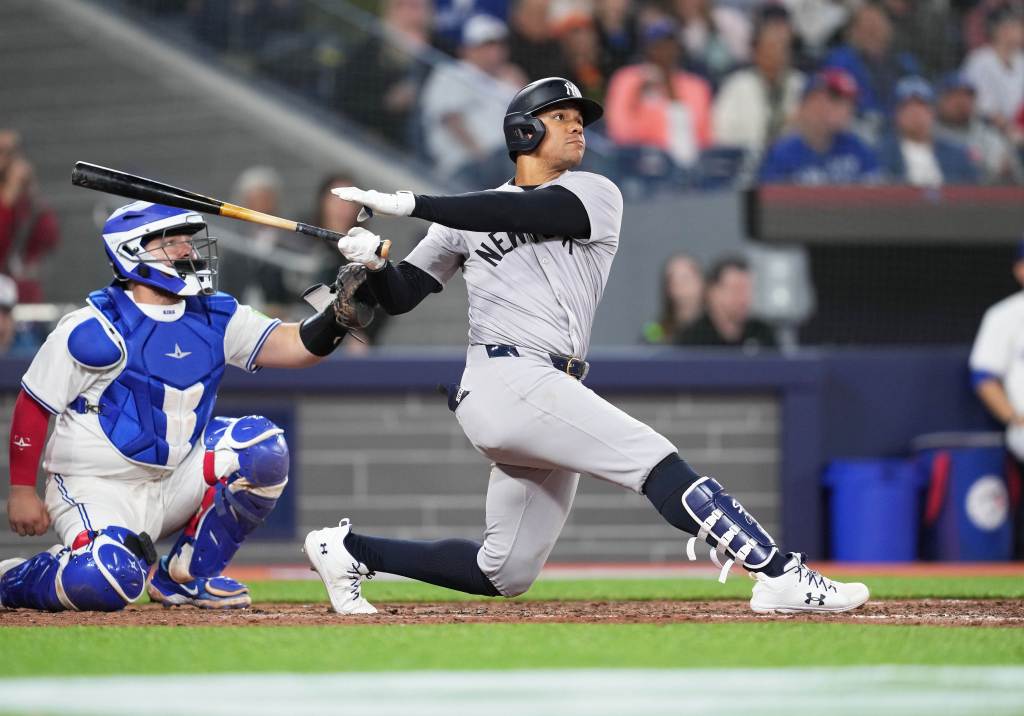 New York Yankees right fielder Juan Soto (22) hits a home run against the Toronto Blue Jays 