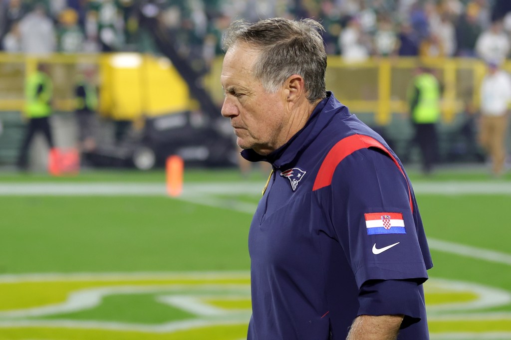 Head coach Bill Belichick of the New England Patriots leaves the field after his team's 27-24 loss in overtime against the Green Bay Packers at Lambeau Field on October 02, 2022 in Green Bay, Wisconsin. 