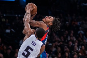 Nets forward Noah Clowney drives to the basket against Kings guard De'Aaron Fox on Sunday night at Barclays Center.