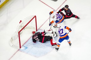 Kyle MacLean (32) of the Islanders scores a goal against Frederik Andersen of the Hurricanes during Game 1.