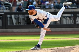 Mets relief pitcher Reed Garrett delivers to the Cardinals in the 11th inning.