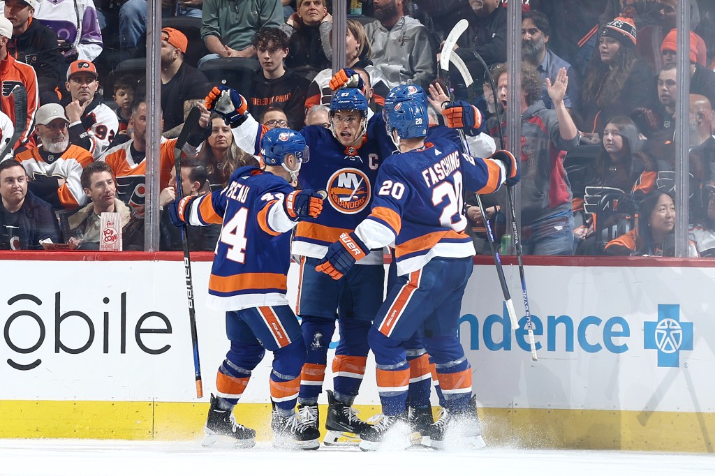 Anders Lee #27 of the New York Islanders (C) reacts with teammates after scoring during the second period