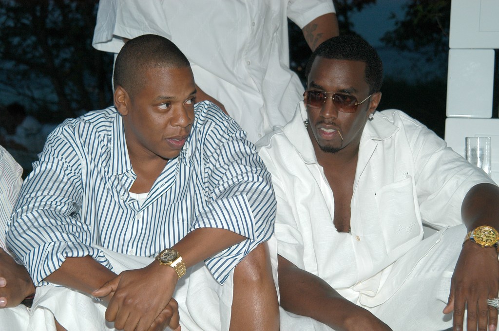 Jay Z and Sean 'P.Diddy' Combs sitting together at the Absolut White Party at East Hampton Residence, New York on August 31, 2003