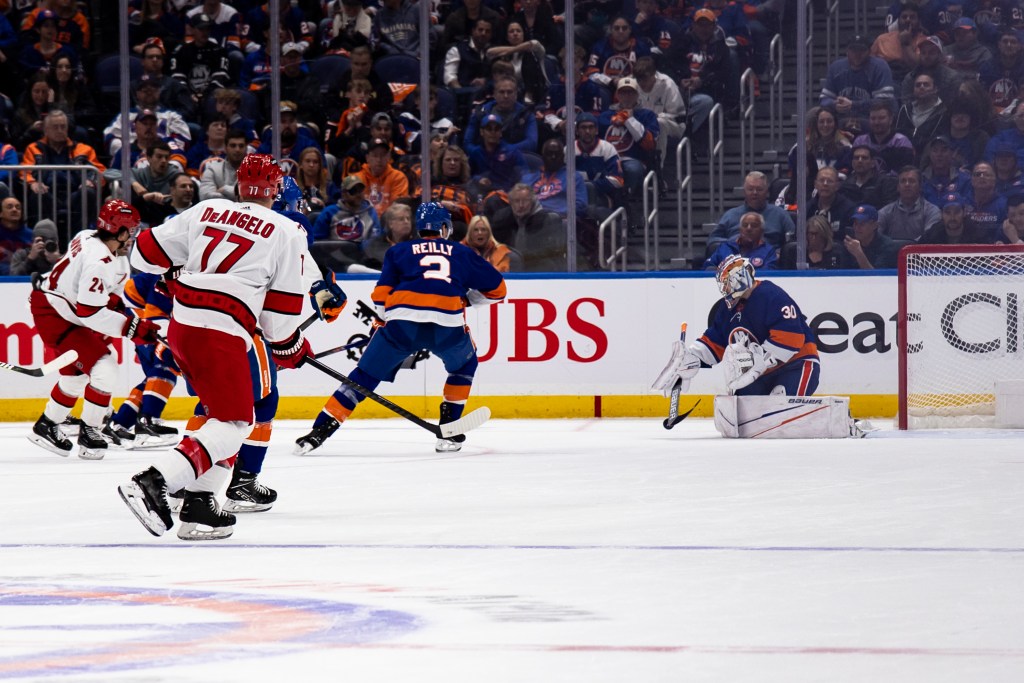 Ilya Sorokin #30 of the New York Islanders makes save against the Carolina Hurricanes