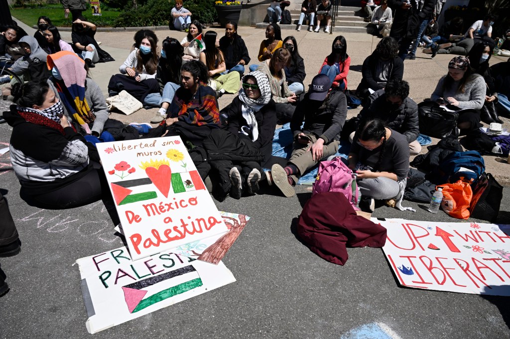 Yale students on the ground blocking an intersection in protest.