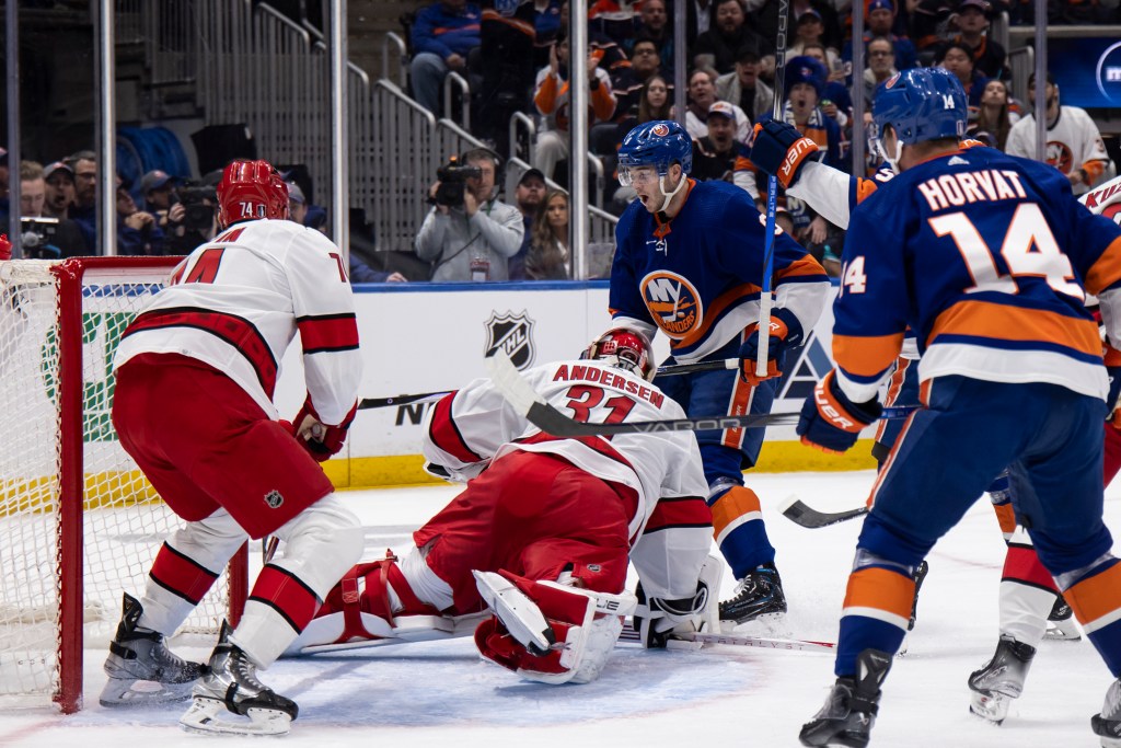 Frederik Andersen #31 of the Carolina Hurricanes makes save against Noah Dobson #8 of the New York Islanders