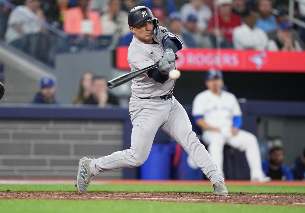Yankees catcher Jose Trevino hits an RBI single against the Toronto Blue Jays during the ninth inning.