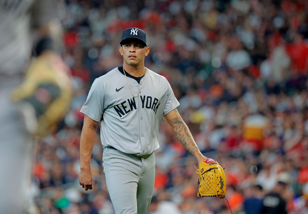 Jonathan Loaisiga of the New York Yankees walking off the mound during the 2024 MLB Season Opener against the Houston Astros at Minute Maid Park