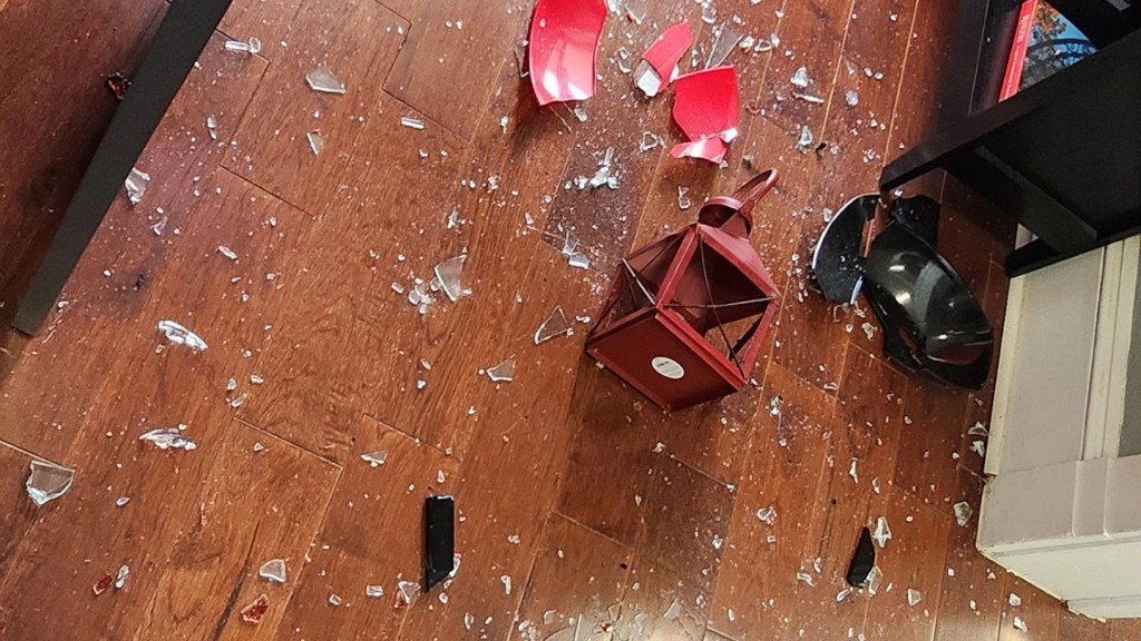 Glass shards and a broken lamp are seen on the floor at the Center for Islamic Life. 