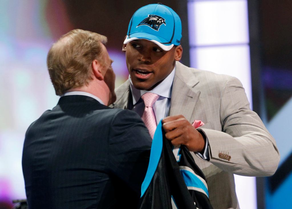Quarterback Cam Newton of Auburn University embraces NFL Commissioner Roger Goodell after being selected as the first overall pick by the Carolina Panthers in the 2011 NFL football Draft in New York, April 28, 2011. 