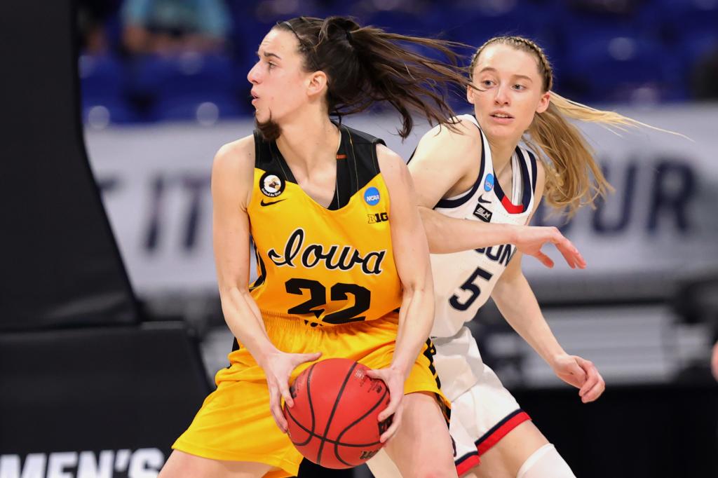  Paige Bueckers #5 of the UConn Huskies defends Caitlin Clark #22 of the Iowa Hawkeyes