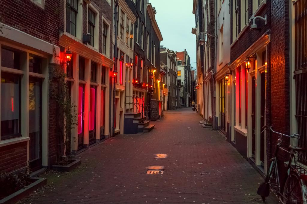 Long view of Amsterdam's red light district at night.