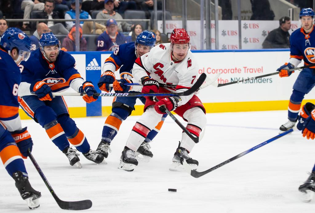 Islanders defend against Dmitry Orlov #7 of the Carolina Hurricanes in the 2nd period