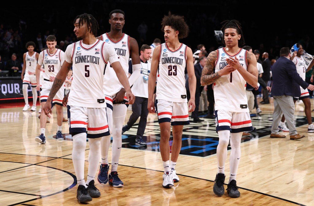 Stephon Castle #5, Jaylin Stewart #3, Samson Johnson #35, and Solomon Ball #1 of the Connecticut Huskies react after a 75-58 victory against the Northwestern Wildcats.