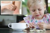 A girl looking at peanuts and a cup of tea