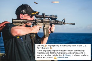 US Navy warship commander Cameron Yaste holding a rifle  