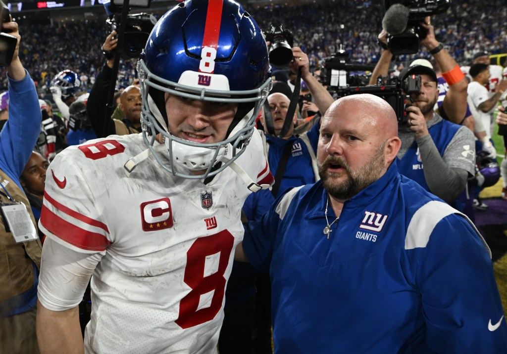 Daniel Jones #8 and head coach Brian Daboll of the New York Giants are seen after defeating the Minnesota Vikings in the NFC Wild Card playoff game at U.S. Bank Stadium on January 15, 2023 in Minneapolis, Minnesota. 