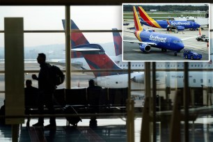 A person walks through the terminal as planes remain at gates at Ronald Reagan Washington National Airport in Arlington, Va., Wednesday, Jan. 11, 2023.