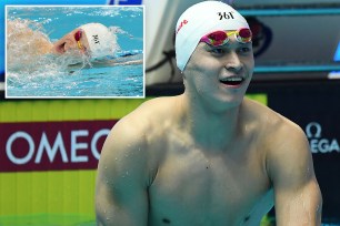 Sun Yang and Qi Guangpu, two athletes, with one of them wearing a swimming cap