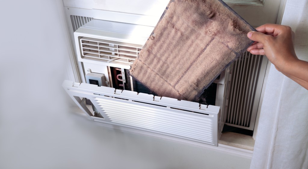 A stock image of a package being stashed inside an AC unit.