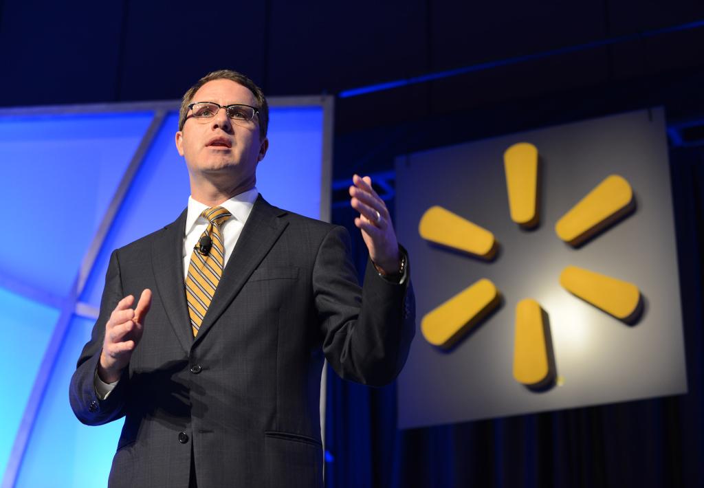 Walmart CEO Doug McMillon giving a speech at the Walmart Product Sustainability Expo amidst an audience of suppliers and associates