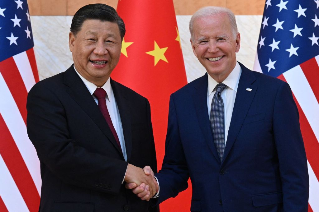 President Joe Biden (R) and China's President Xi Jinping (L) shake hands as they meet on the sidelines of the G20 Summit in Nusa Dua on the Indonesian resort island of Bali on November 14, 2022.