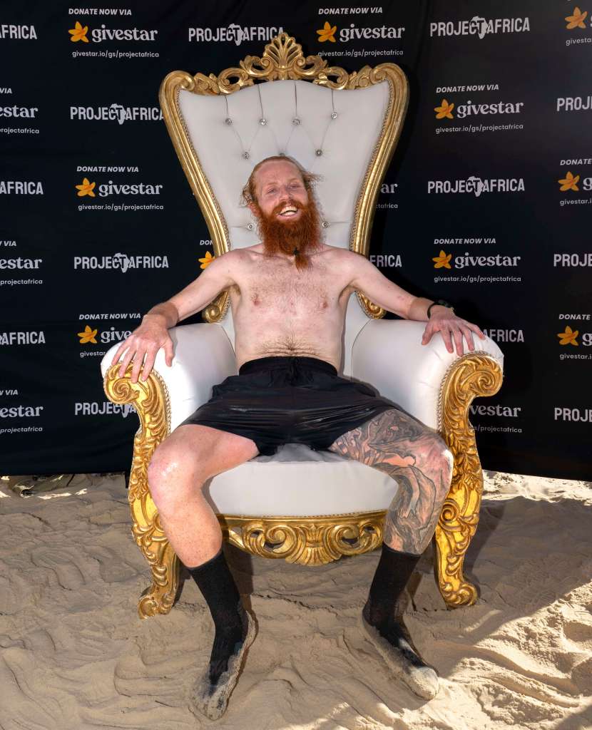 Russ Cook sits down after arriving to the finish line in Ras Angela in Tunis, Tunisia, on April 7, 2024.