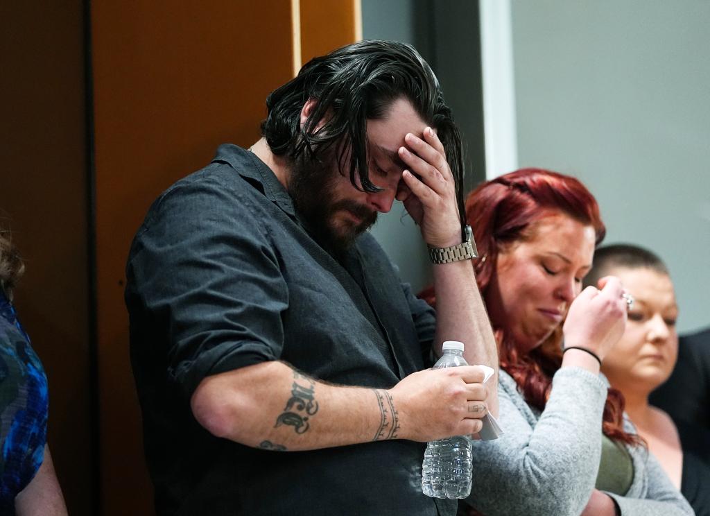 Devon Vestal, front, and his wife, Jess, react as they listen during a news conference to announce plans to sue the Littleton, Colo., school district for abuse suffered by their autistic child while riding the bus to class Tuesday, April 9, 2024, in Denver.