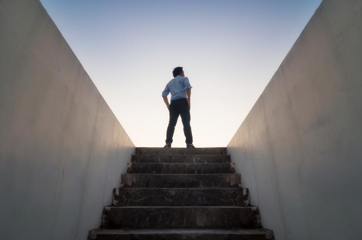 Businessman climbed on top of the stairs going to the city, Ambitions concept and Success business.