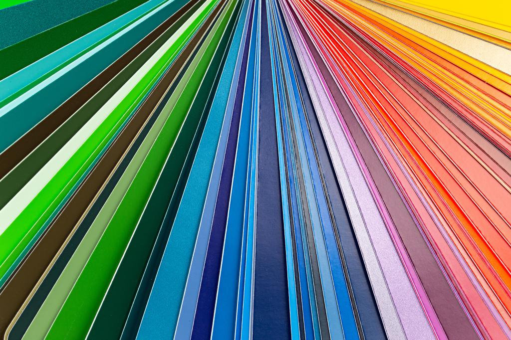 Color guide fan chart catalog spectrum of all kind of various colors to choose paint from book DIY renovation home improvement concept macro close-up abstract rainbow background