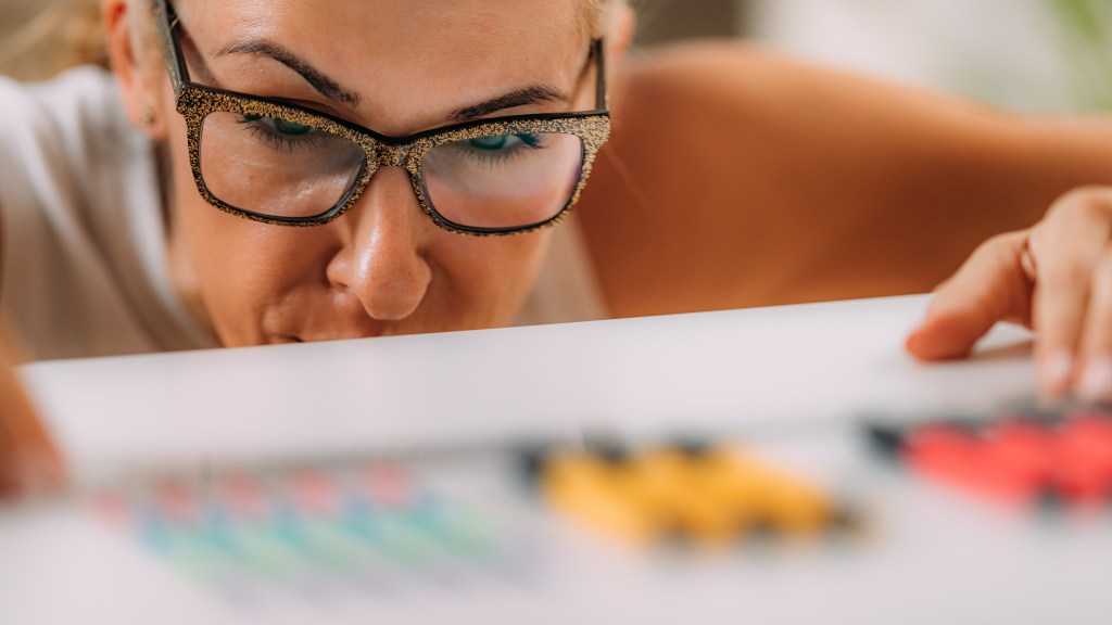 Woman with OCD – Obsessive compulsive disorder concept. Placing paperclips in a straight line.