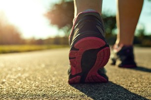 Close up of a woman running on a road.