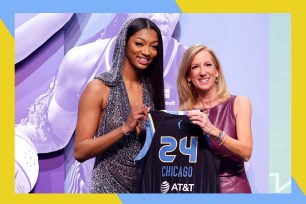 Angel Reese (L) poses with a Chicago Sky jersey alongside WNBA commissioner Cathy Engelbert.