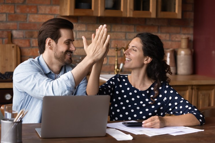 A couple discovers the benefits of online banking.