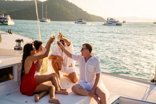 A group of friends enjoy their vacation on a boat.