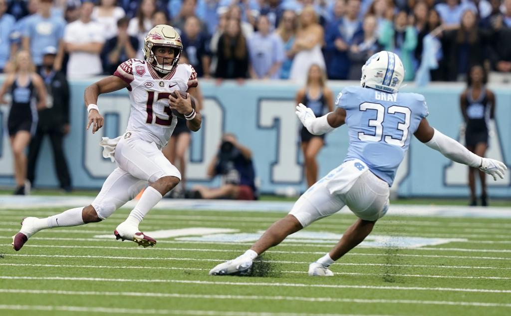 North Carolina linebacker Cedric Gray looks to tackle Florida State quarterback Jordan Travis during a game last season.