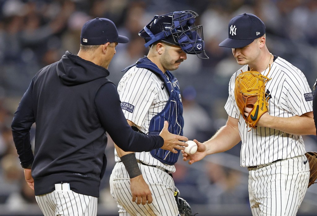 Aaron Boone takes Clarke Schmidt out in the sixth inning of the Yankees' 7-3 win over the A's. 