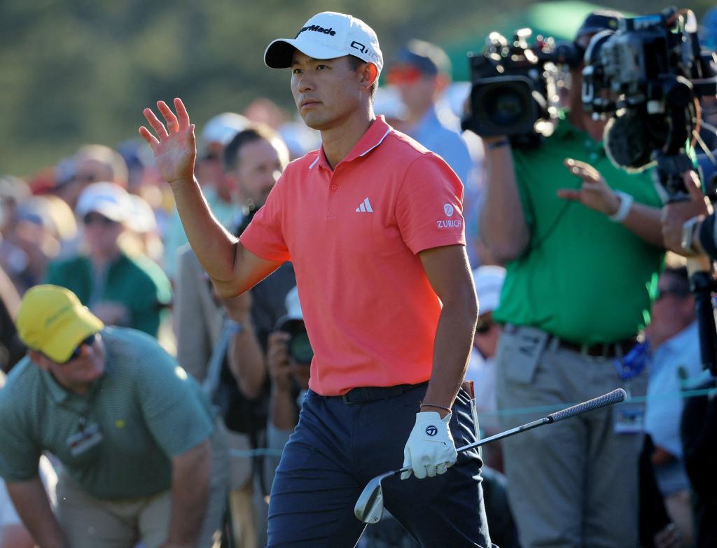 Collin Morikawa acknowledges the crowd after hitting a pitch shot on to the 18th green during the third round of the Masters.