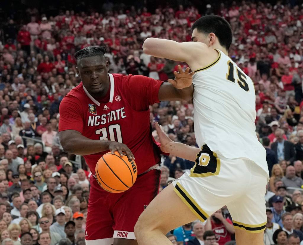 North Carolina State's DJ Burns Jr. looks to make a move on Zach Edey during Purdue's victory.