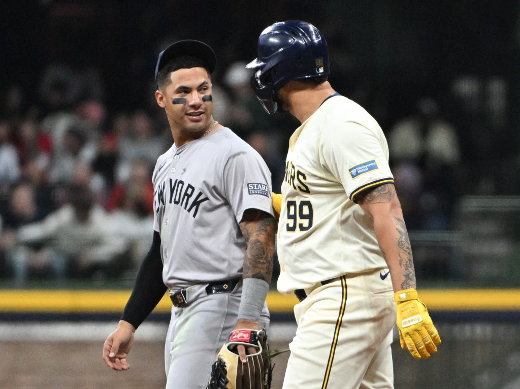 Gary Sanchez talks with former teammate Gleyber Torres during a pitching change on Friday.