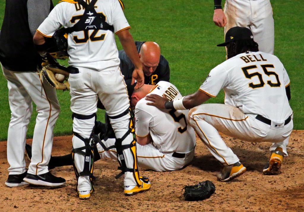 Nick Burdi #57 of the Pittsburgh Pirates lays injured on the ground in the eighth inning against the Arizona Diamondbacks at PNC Park on April 22, 2019 in Pittsburgh, Pennsylvania. 