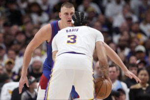 DENVER, COLORADO - APRIL 20: Nikola Jokic #15 of the Denver Nuggets guards Anthony Davis #3 of the Los Angeles Lakers in the fourth quarter during game one of the Western Conference First Round Playoffs at Ball Arena on April 20, 2024 in Denver, Colorado. NOTE TO USER: User expressly acknowledges and agrees that, by downloading and or using this photograph, User is consenting to the terms and conditions of the Getty Images License Agreement. (Photo by Matthew Stockman/Getty Images)