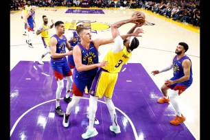 LOS ANGELES, CALIFORNIA - APRIL 25: Anthony Davis #3 of the Los Angeles Lakers takes a shot against Nikola Jokic #15 of the Denver Nuggets in the first quarter during game three of the Western Conference First Round Playoffs at Crypto.com Arena on April 25, 2024 in Los Angeles, California. (Photo by Ronald Martinez/Getty Images)