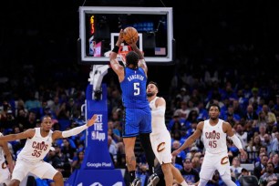 ORLANDO, FLORIDA - APRIL 25: Paolo Banchero #5 of the Orlando Magic goes up for a shot against Max Strus #1 of the Cleveland Cavaliers during the third quarter of game three of the Eastern Conference First Round Playoffs at Kia Center on April 25, 2024 in Orlando, Florida. NOTE TO USER: User expressly acknowledges and agrees that, by downloading and or using this photograph, User is consenting to the terms and conditions of the Getty Images License Agreement. (Photo by Rich Storry/Getty Images)