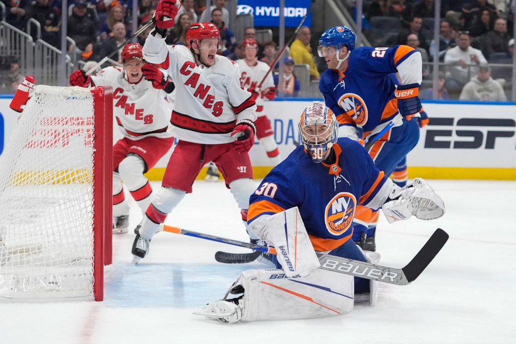 Jake Guentzel (59, left) celebrates after Dmitry Orlov (not pictured) scores a first-period goal on Ilya Sorokin during Game 3 between the Islanders and Hurricanes. 