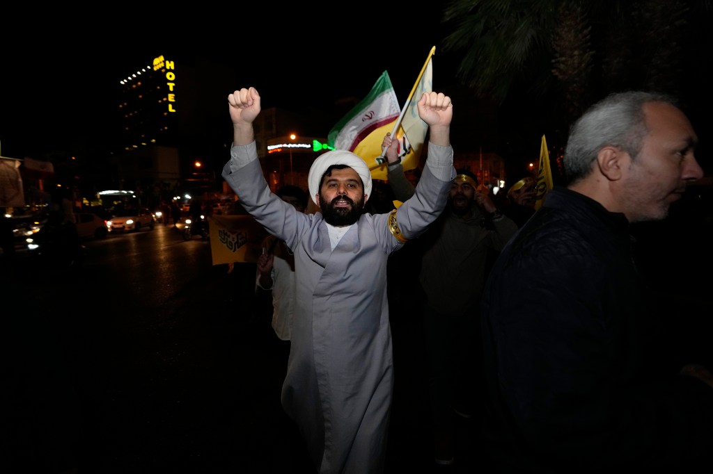 An Iranian cleric chants slogans while attending an anti-Israeli gathering at the Felestin (Palestine) Square in Tehran, Iran.